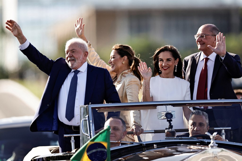 Brazil's President Luiz Inacio Lula da Silva and his wife Rosangela "Janja" da Silva wave to supporters. They were accompanied by Brazil's Vice President Geraldo Alckmin and his wife Maria Lucia Ribeiro Alckmin on the day of Lula's swearing-in ceremony in Brasilia, Brazil on Jan. 1, 2023. 