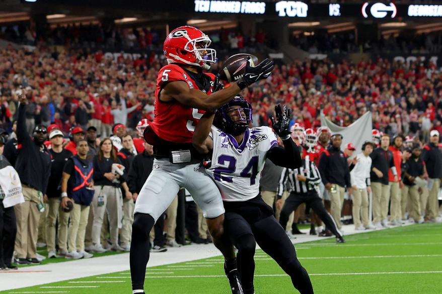 Adonai Mitchell #5 of the Georgia Bulldogs catches a touchdown pass