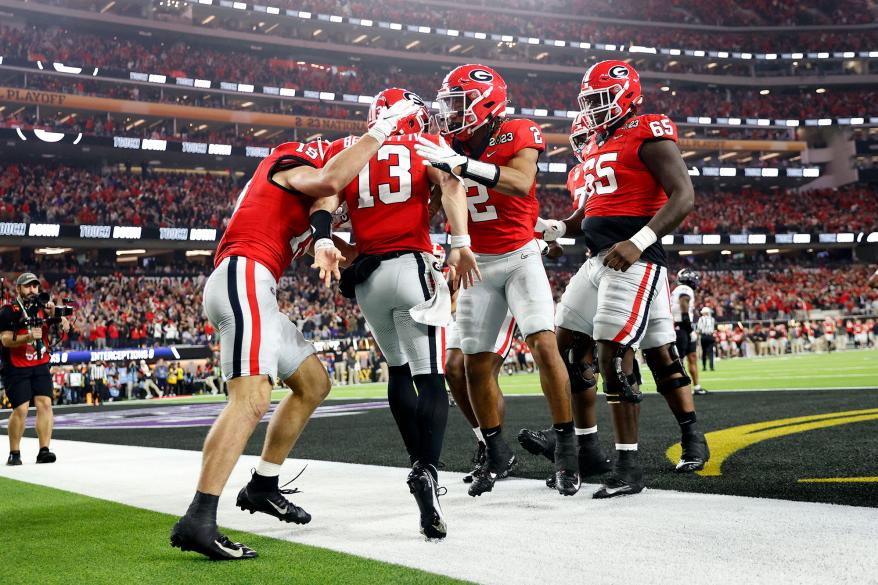 Stetson Bennett #13 of the Georgia Bulldogs celebrates with teammates