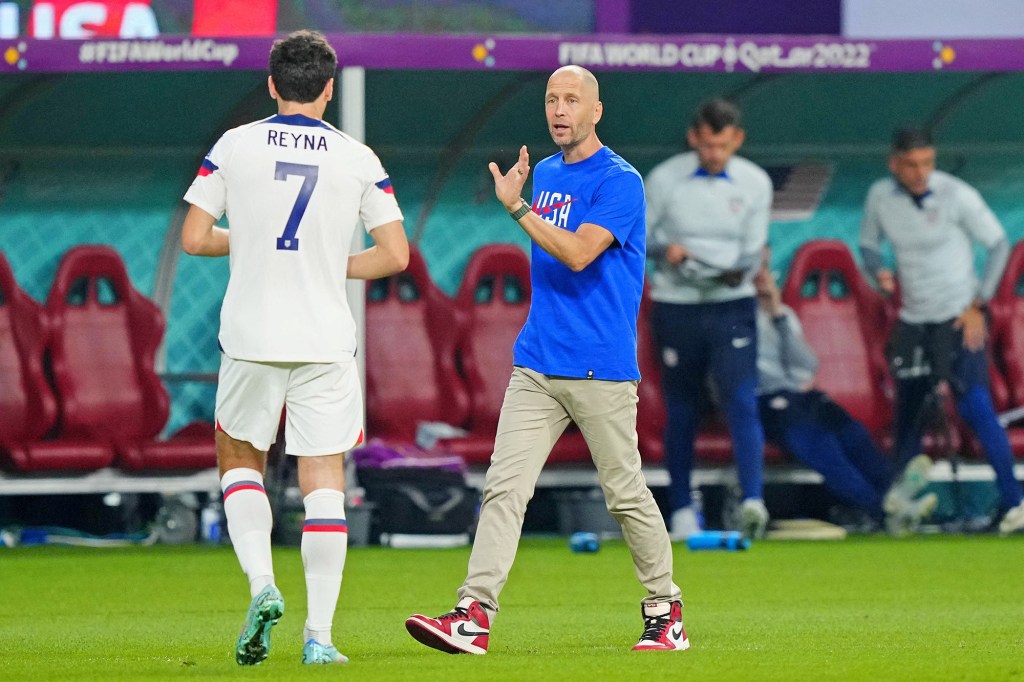 Gregg Berhalter talks to Gio Reyna (7) during the USMNT's World Cup match against the Netherlands on Dec. 3, 2022.