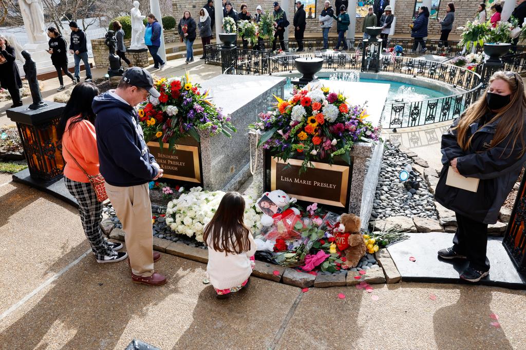 Fans visit the grave of Lisa Marie Presley during her memorial.