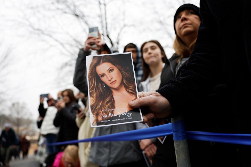 A view of the program as fans gather to pay their respects at the memorial for Lisa Marie Presley.