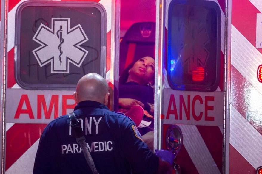 Woman being put in ambulance.