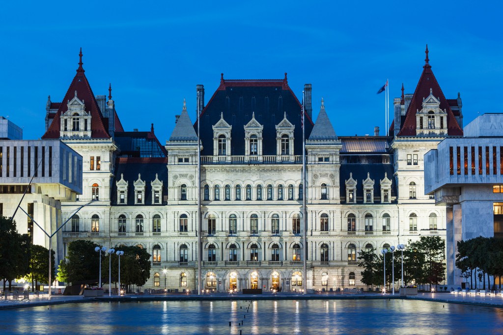 A photo of the state Capitol from Empire State Plaza with a dark blue sky