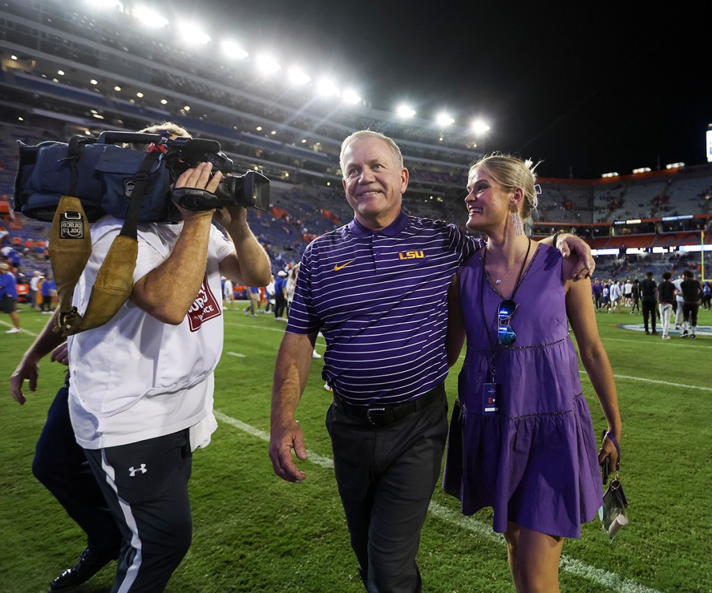 Head coach Brian Kelly of the LSU Tigers reacts with his daughter Grace Kelly after defeating the Florida Gators 45-45 in a game at Ben Hill Griffin Stadium on October 15, 2022 in Gainesville, Florida.
