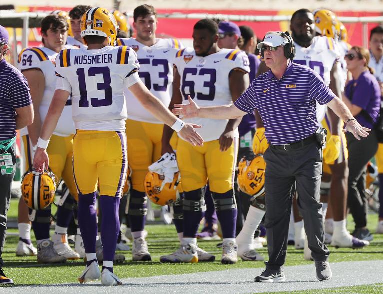 LSU head coach Brian Kelly congratulates quarterback Garrett Nussmeier (13) after a touchdown against Purdue during the Cheez-It Citrus Bowl at Camping World Stadium in Orlando, Florida, on Monday, Jan. 2, 2023.