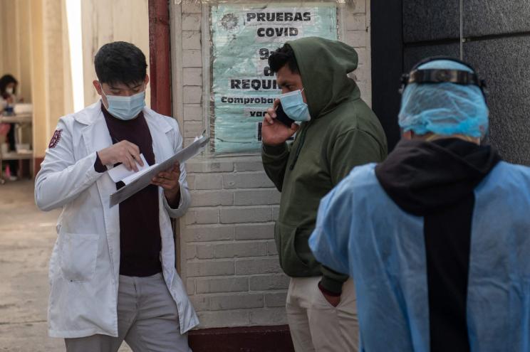 A man waits in line to get tested for Covid-19 outside a hospital in Mexico City, on December 16, 2022.