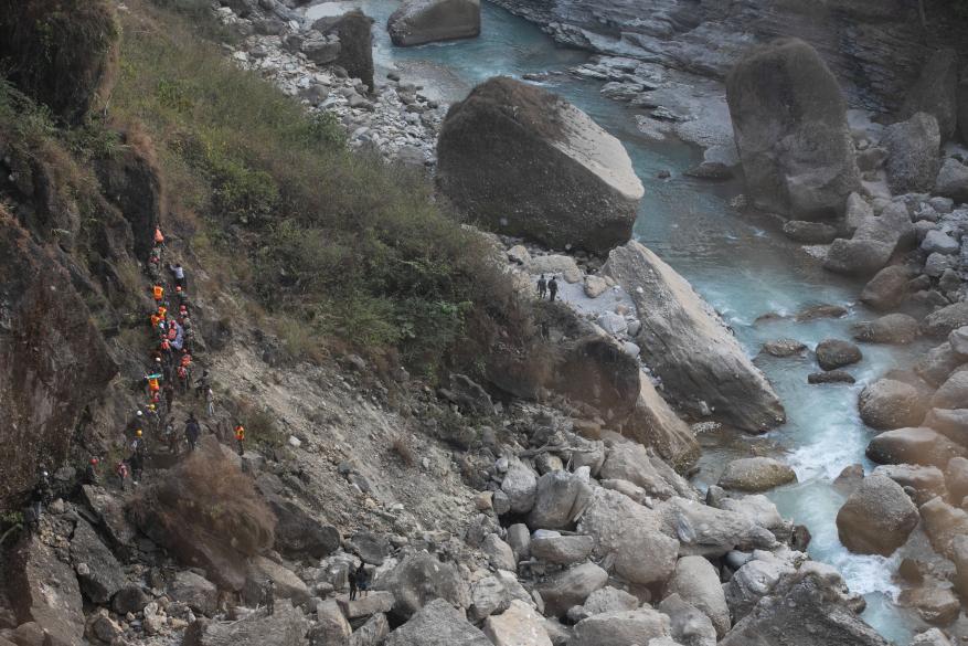 Nepal army, Police, AFP Rescuers recover the body of a victim who died in a Yeti Airlines plane crash in Pokhara.