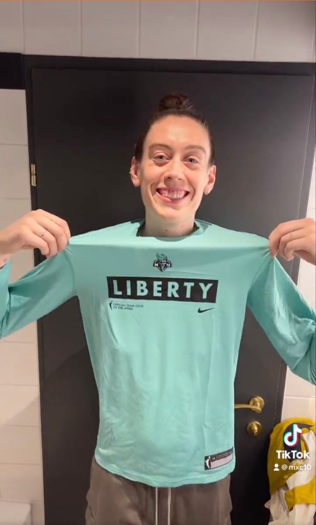 Breanna Stewart poses in a Liberty shirt after announcing her free agency move on Feb. 1, 2023.