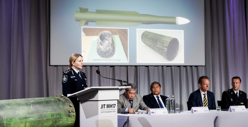 A part of the BUK-TELAR rocket that was fired on the MH17 flight is displayed on a table as Australian Joint Investigation Team (JIT) member Jennifer Hurst speaks in Bunnik on May 24, 2018.