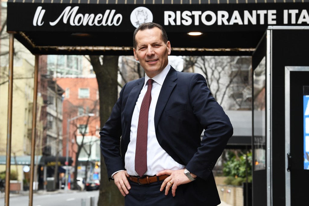 Photo of Steve Haxhiaj in front of the awning of Il Monello.