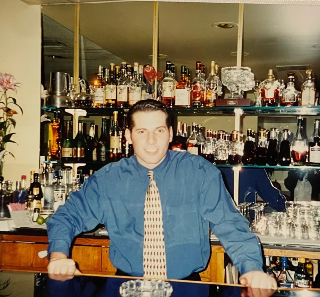 Haxhiaj behind the bar at the old location.