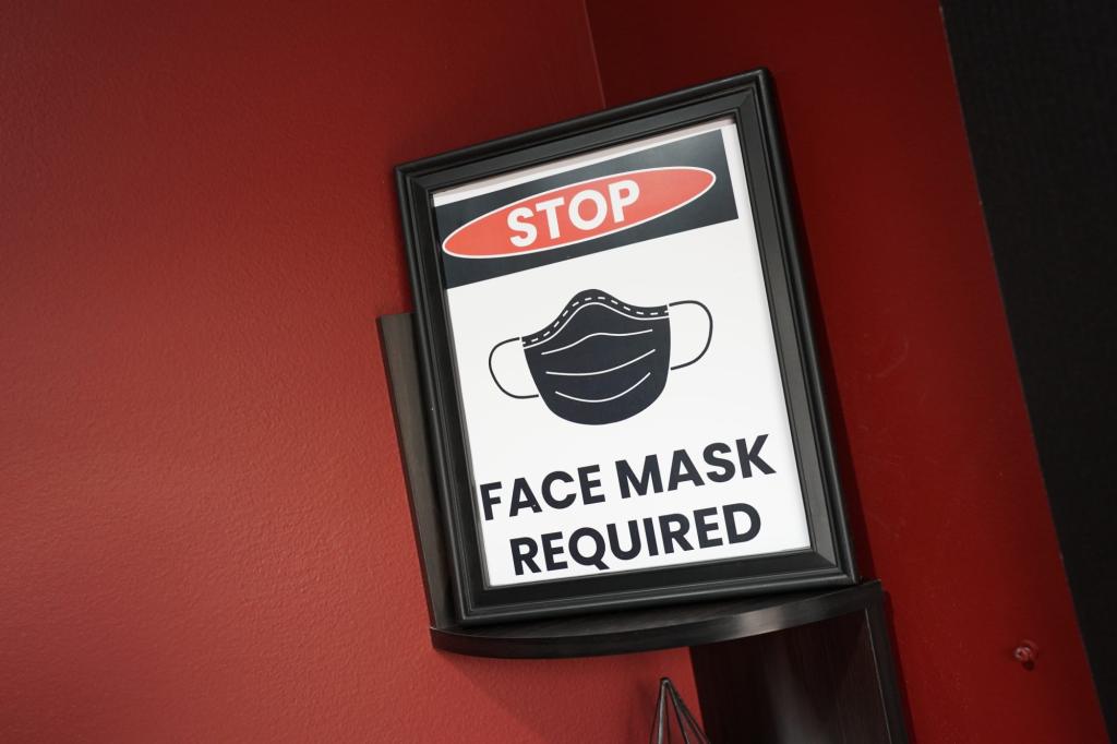 A general view of a "face mask required" sign in the lobby of a salon in Hawthorne, NJ on February 16, 2022.