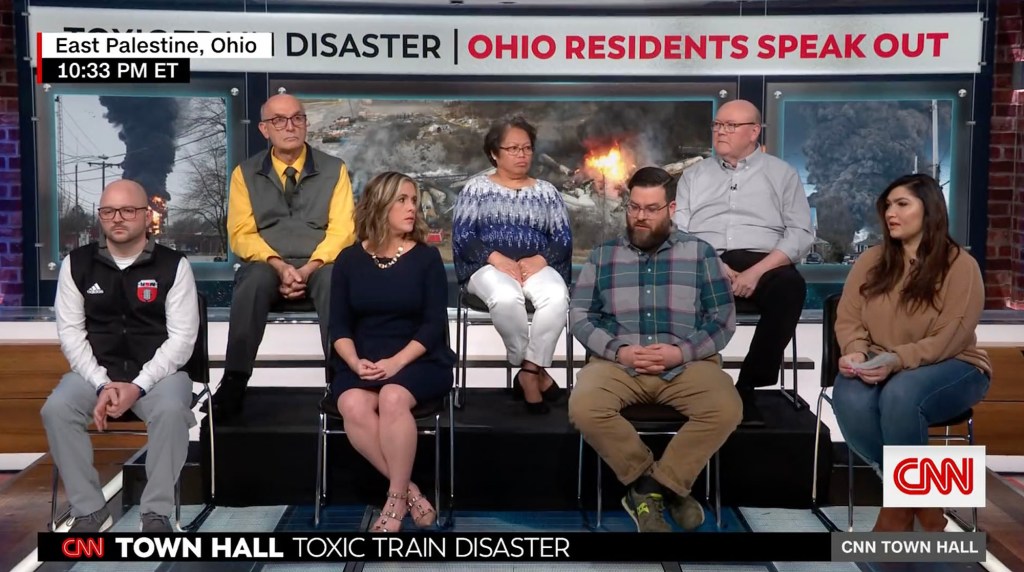 some residents of East Palestine are pictured at a town hall.