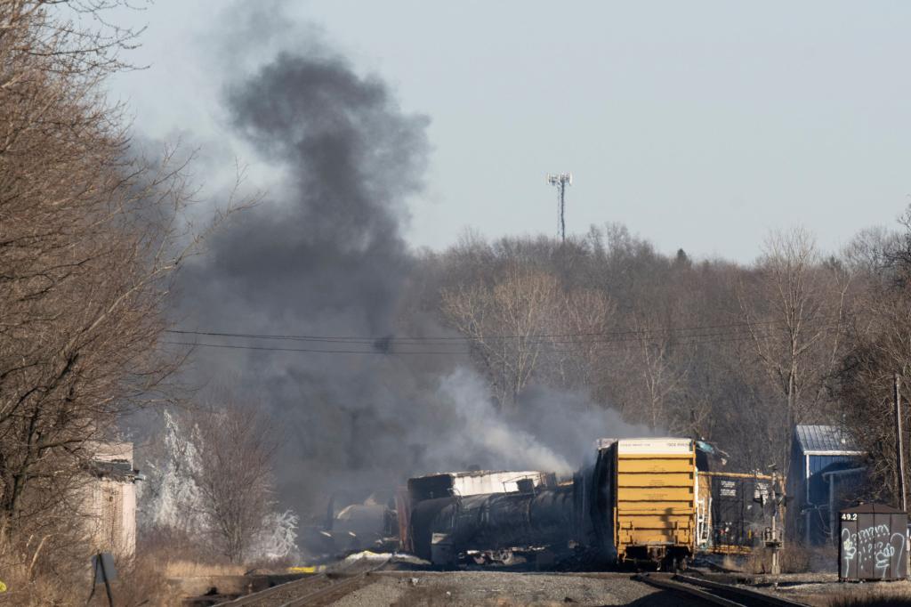 Smoke rises from a derailed cargo train in East Palestine, Ohio, on February 4, 2023.