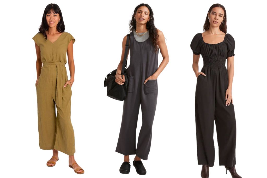 Three women in jumpsuits, one in olive green, the other in grey with a bag, and the last in black.