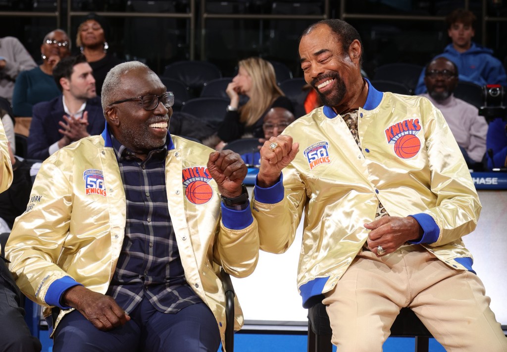 Walt "Clyde" Frazier (right) fist bumps with Earl Monroe during a halftime ceremony honoring the Knicks' 1972-73 championship team.