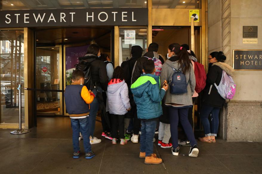 Migrant families arriving at the Stewart Hotel.