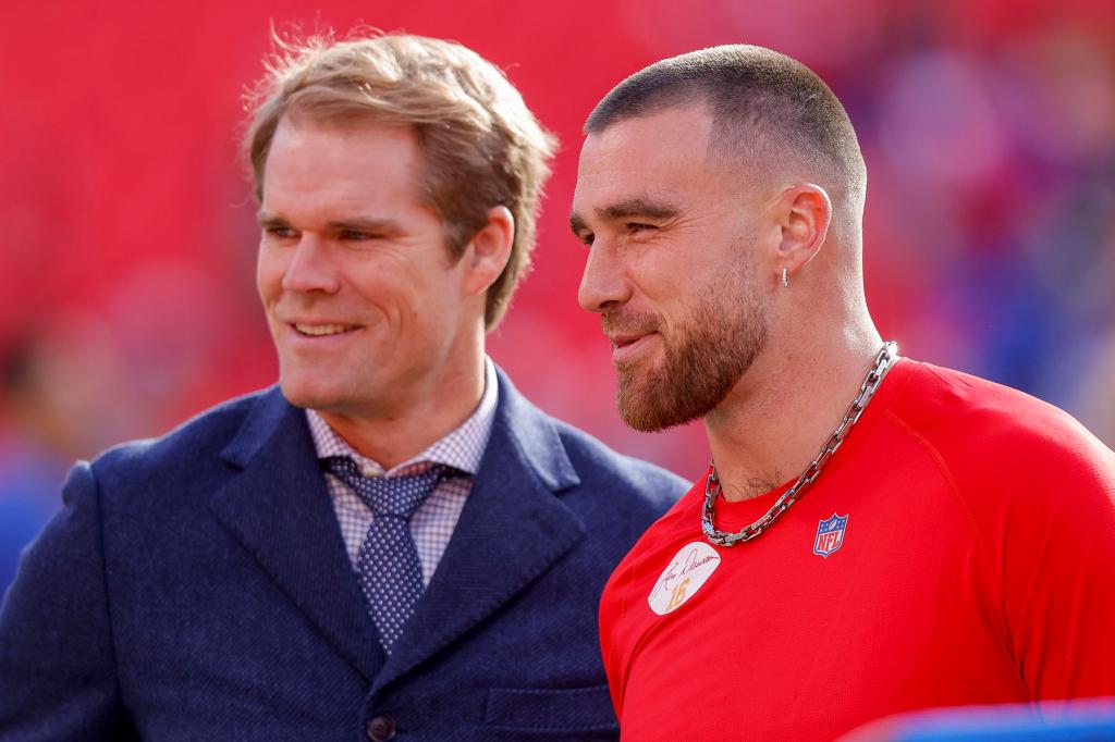 Travis Kelce #87 of the Kansas City Chiefs and Fox Sports broadcaster Greg Olsen speak during pregame warmups prior to the game against the Los Angeles Rams at Arrowhead Stadium on November 27, 2022 in Kansas City, Missouri.