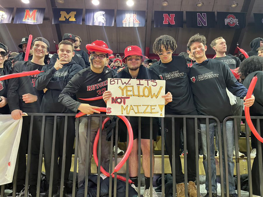 Matt Mucciacciaro holds a sign, surrounded by other Rutgers fans before a game against Michigan on February 23, 2023.