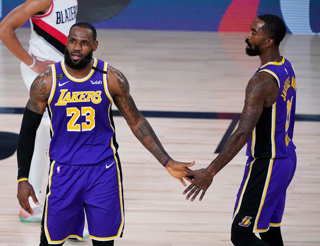 LeBron James #23 of the Lakers celebrates a play with teammate JR Smith #21 during the first half of Game 3 of the first round of the playoffs against the Trail Blazers at the AdventHealth Arena at the ESPN Wide World Of Sports Complex on Aug. 22, 2020 in Lake Buena Vista, Florida.