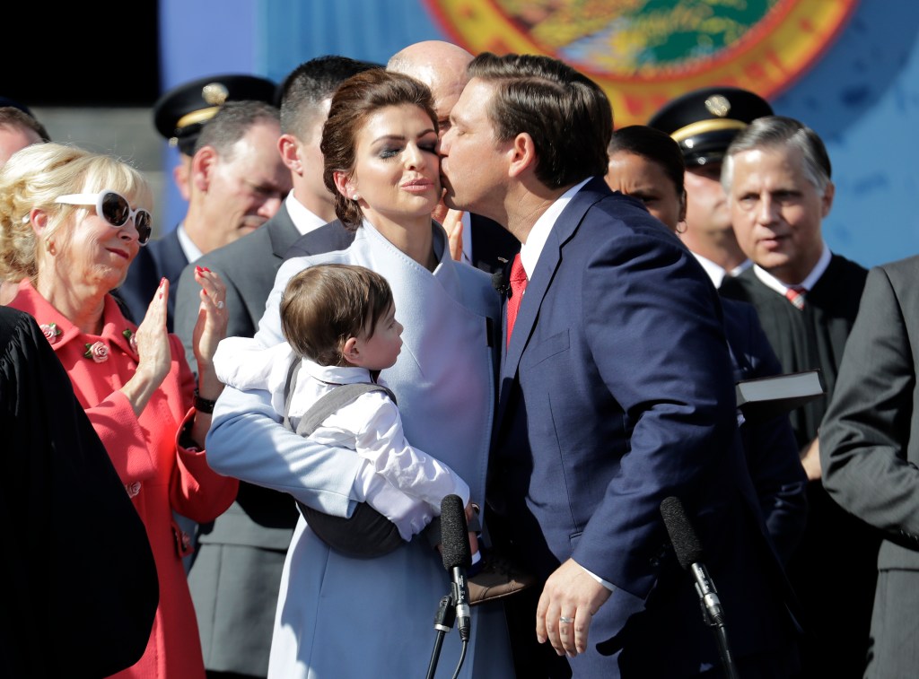 Florida Governor Ron DeSantis, right, kisses his wife Casey during an inauguration ceremony with their son Mason, Tuesday, Jan. 8, 2019, in Tallahassee, Fla. 