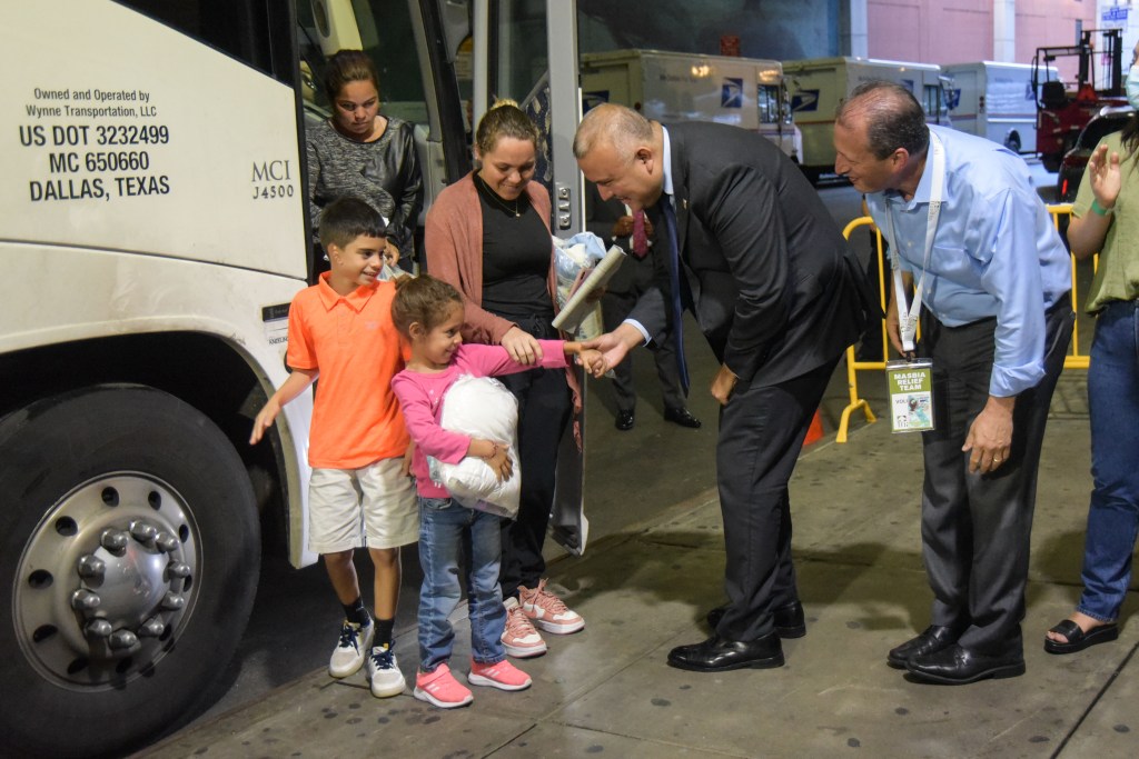 New York City Comptroller Brad Lander (right, blue shirt) greeting migrants arriving from Texas.