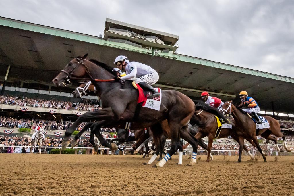 Horses racing at Belmont on a dirt track