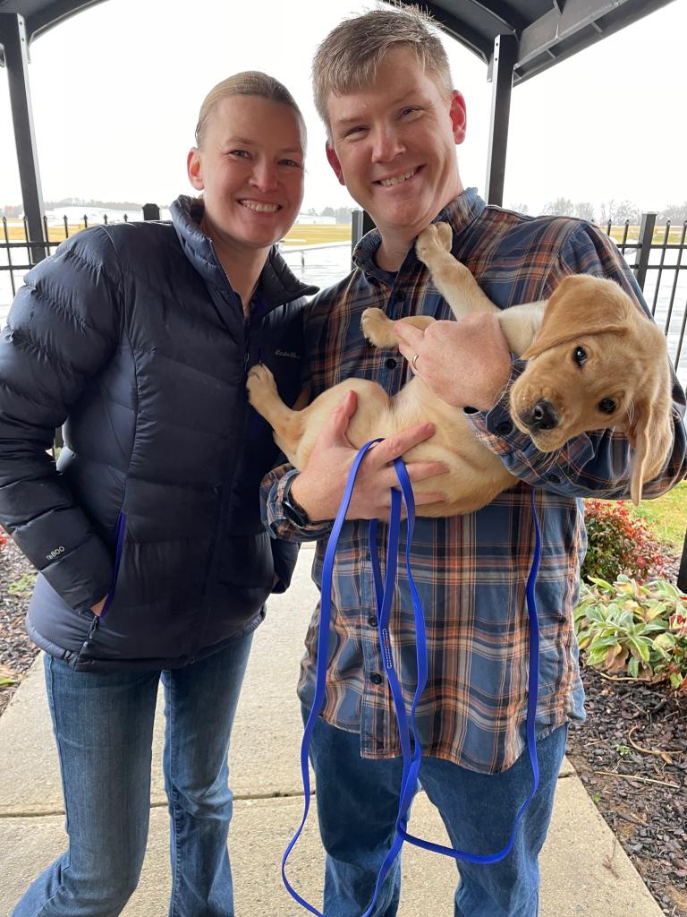 Guiding Eyes for the Blind puppy raisers with their pup.