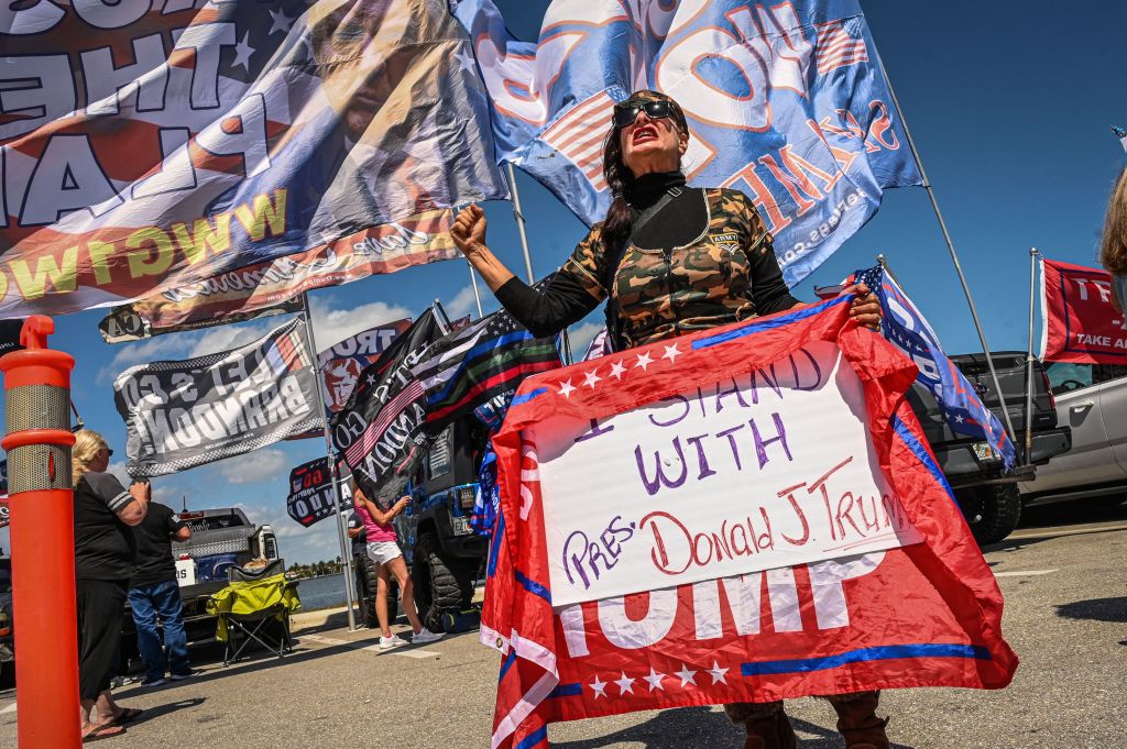 Supporters of former President Donald Trump protest near Mar-a-Lago in Florida on Tuesday. Trump urged his supporters to "protest" if he is arrested by the Manhattan district attorney.