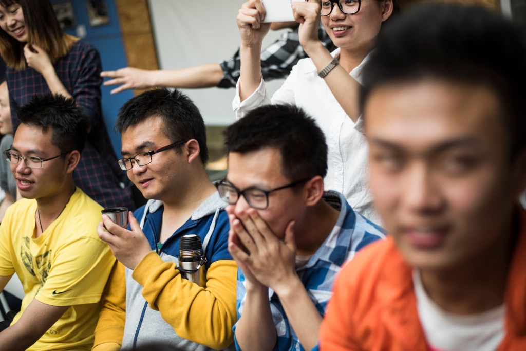 Chinese students laughing together.