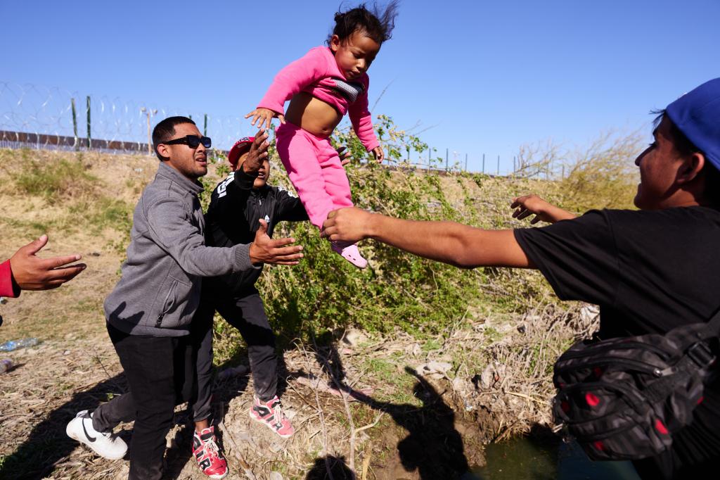 Baby being tossed over the border