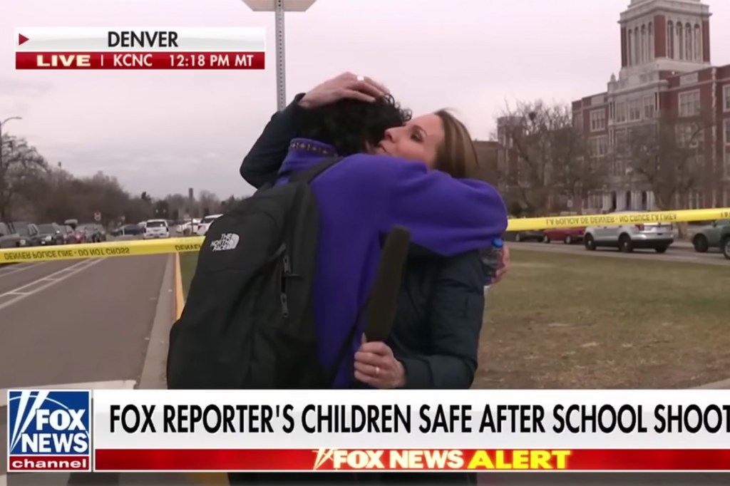 Fox reporter Alicia Acuna son walks over into the camera's view and the pair embrace in a tight hug. 