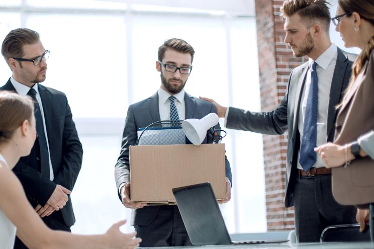 Business colleagues say goodbye to the dismissed employee.