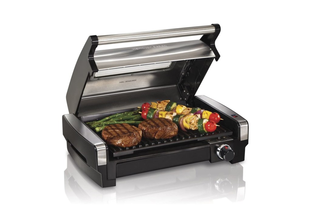 silver and black electric grill with food on top