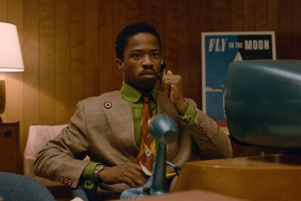 Salesman Herb Porter (Dewshane Williams) makes a call on the Viddicon in "Hello Tomorrow! He's seated in front of a TV set and there's a microphone in front of him. He's wearing a headset that you would see on telephone operators in the 1950s.