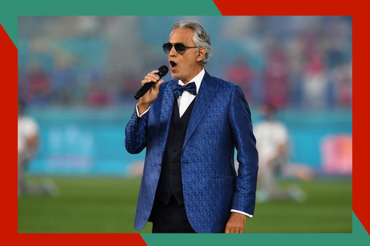 Andrea Bocelli sings into a microphone.