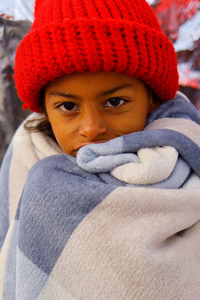 A kid is pictured while migrants, mostly from Venezuela and traveling by train, queue to board a bus as they try to reach the United States, in Samalayuca, on the outskirts of Ciudad Juarez, Mexico, March 17, 2023.