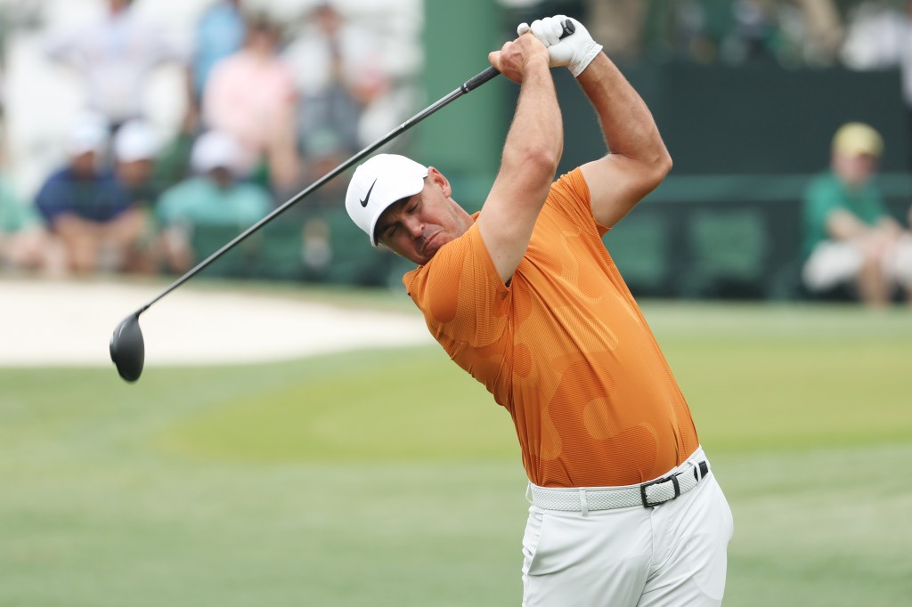 Brooks Koepka plays his shot from the third tee during a practice round prior to the 2023 Masters Tournament.