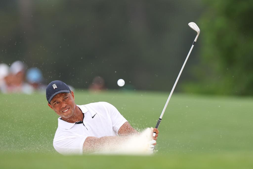 AUGUSTA, GEORGIA - APRIL 06: Tiger Woods of the United States plays a shot from a bunker on the 18th hole during the first round of the 2023 Masters Tournament at Augusta National Golf Club on April 06, 2023 in Augusta, Georgia. (Photo by Andrew Redington/Getty Images) The Masters - Round One