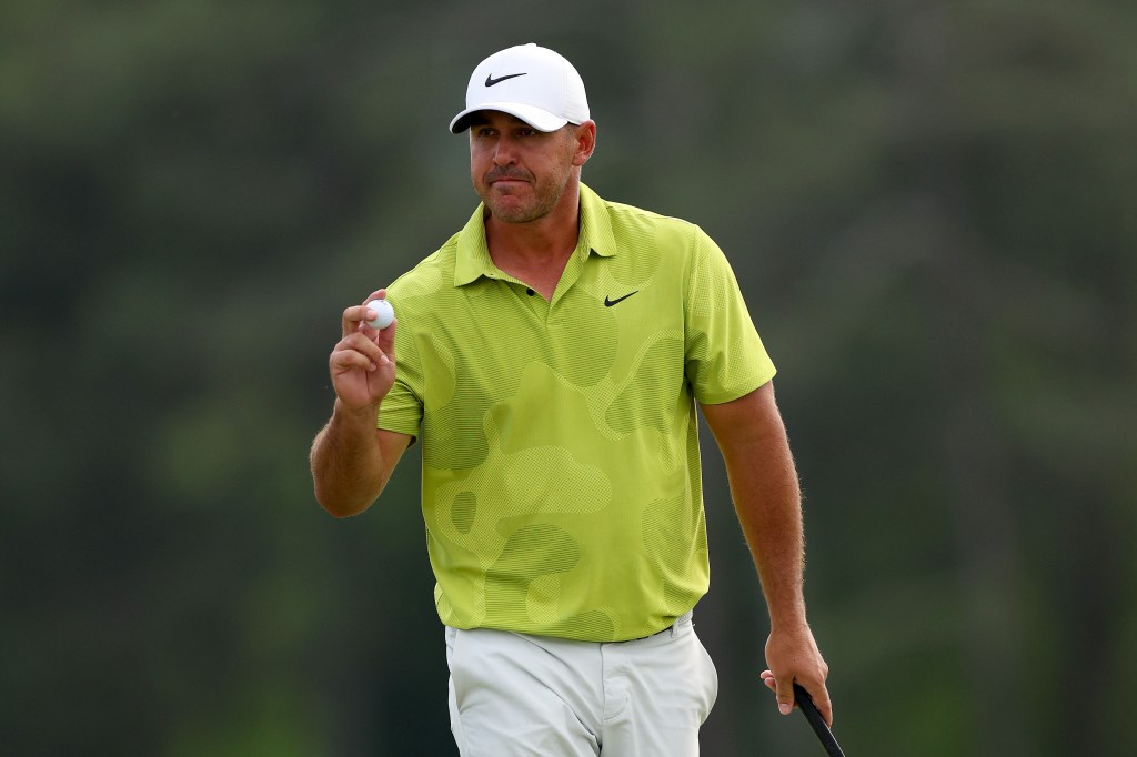 Brooks Koepka reacts to his birdie on the 18th green during the first round of the 2023 Masters Tournament.