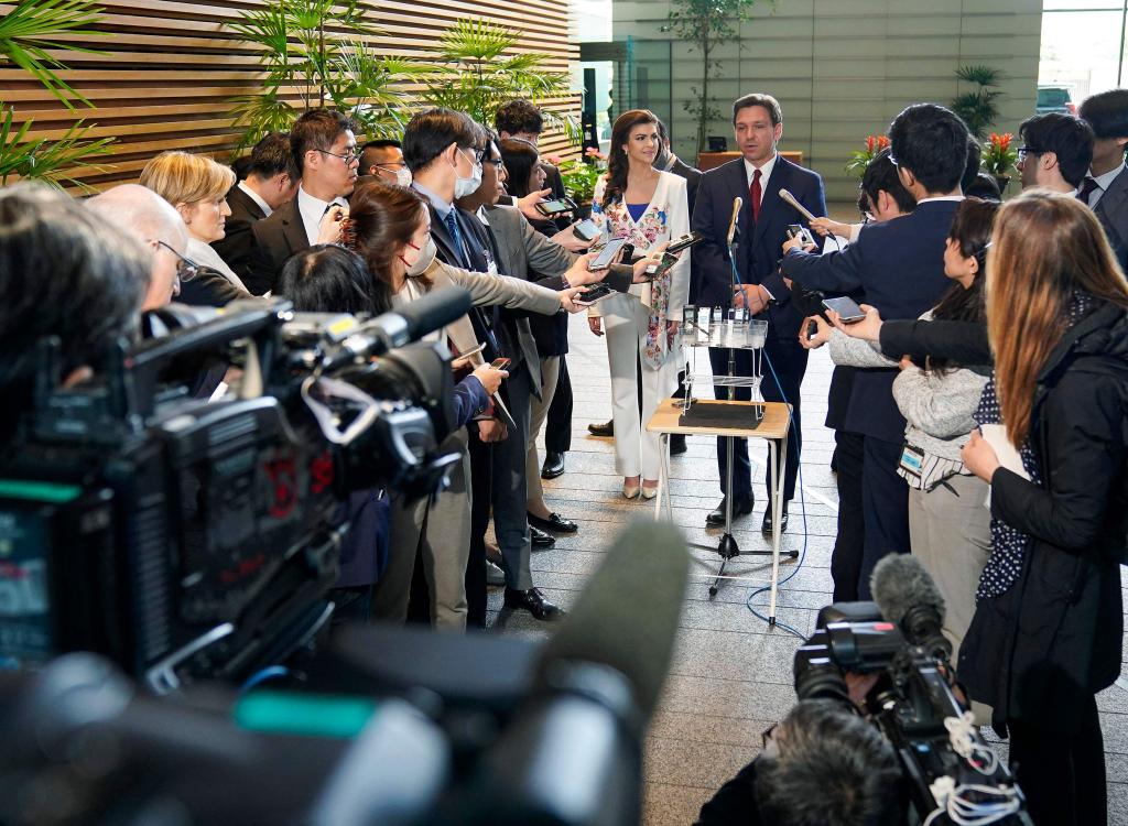 Florida Governor Ron DeSantis (R) talks with journalists his wife Casey looks on after meeting Japanese Prime Minister Fumio Kishida