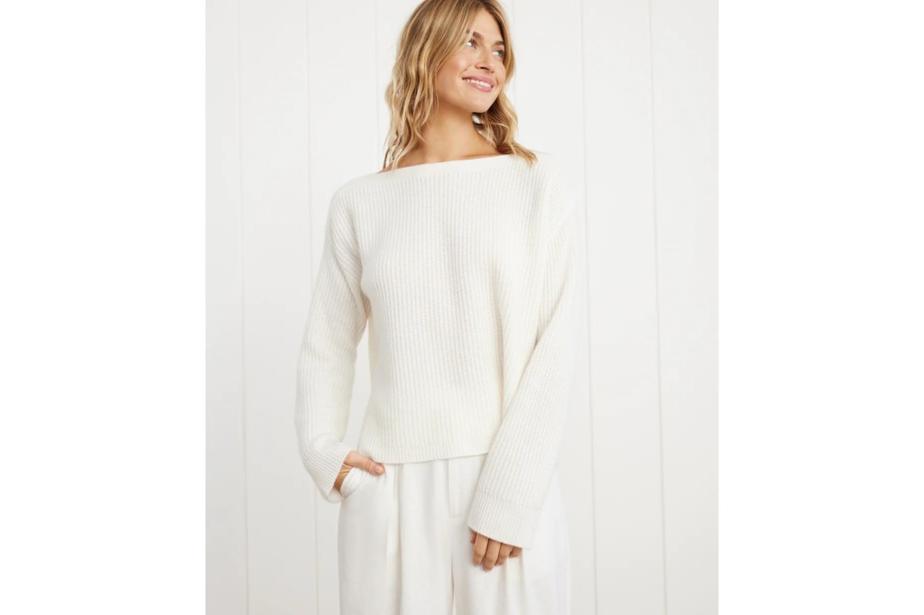 model wearing white boatneck sweater with wide sleeves