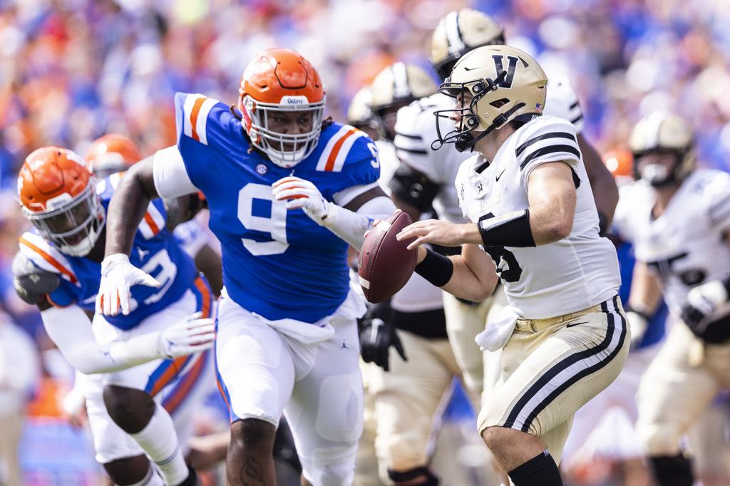 Ken Seals #8 of the Vanderbilt Commodores looks to pass against Gervon Dexter #9 of the Florida Gators during the first quarter of a game at Ben Hill Griffin Stadium on October 09, 2021 in Gainesville, Florida.