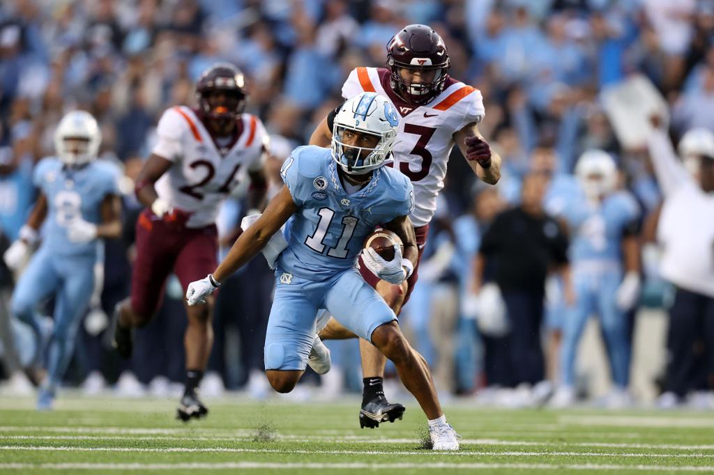 Josh Downs #11 of the University North Carolina runs with the ball during a game between Virginia Tech and North Carolina at Kenan Memorial Stadium on October 1, 2022 in Chapel HIll, North Carolina.