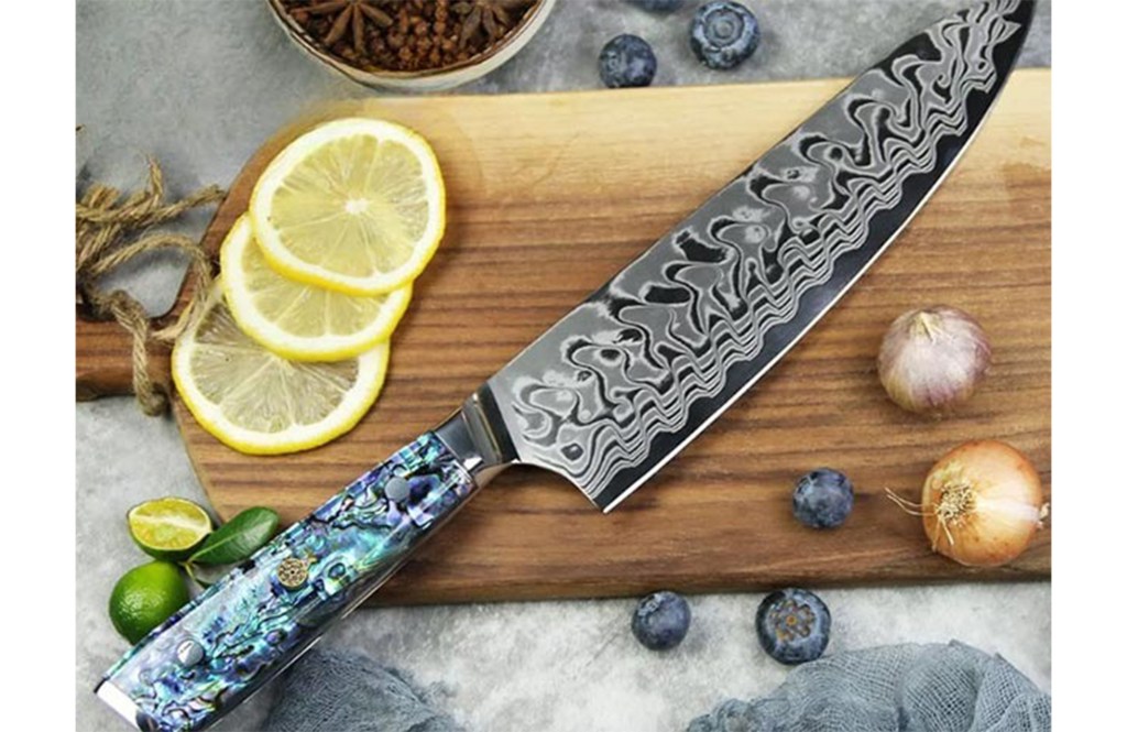 Detailed chef's knife on a cutting board. 