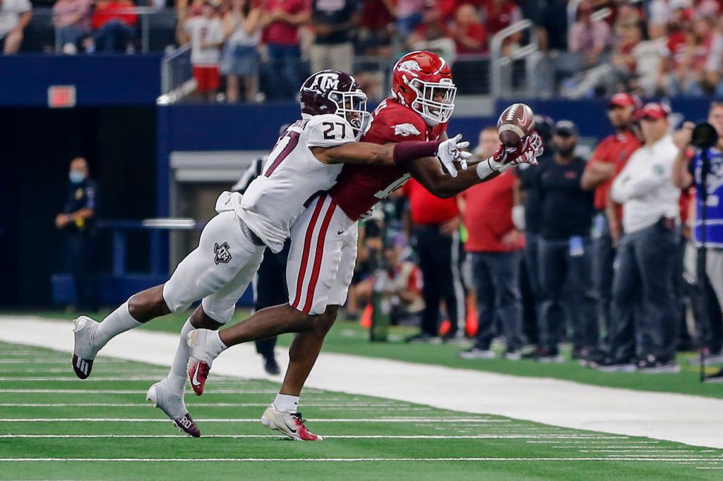 Arkansas Razorbacks wide receiver Tyson Morris (19) catches a pass as Texas A&M Aggies defensive back Antonio Johnson (27) tries to defend during the Southwest Classic game between the Texas A&M Aggies and the Arkansas Razorbacks on September 25, 2021 at AT&T Stadium in Arlington, Texas.