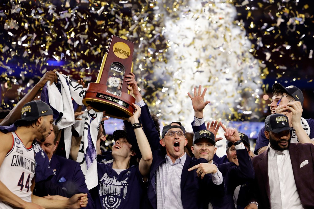 Head coach Dan Hurley of the Connecticut Huskies celebrates with his team after defeating the San Diego State Aztecs 76-59 during the NCAA Men's Basketball Tournament National Championship