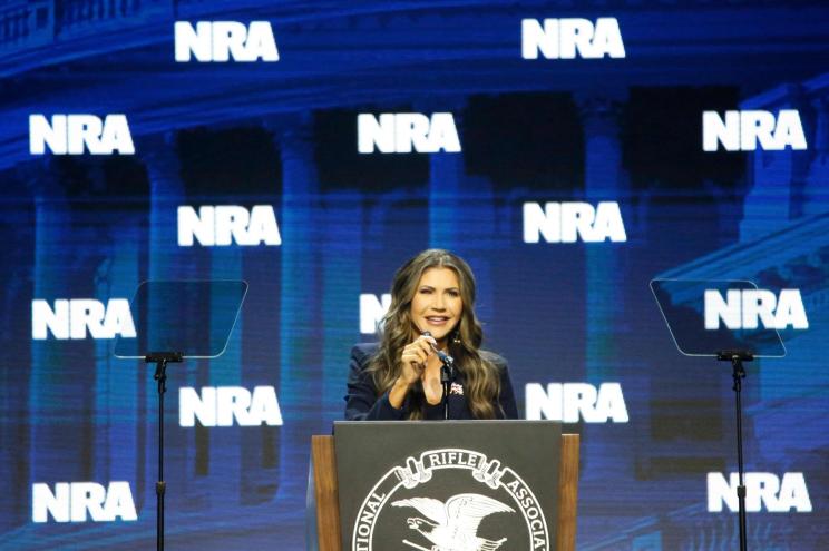 South Dakota Gov. Kristi Noem claimed her 1-year-old granddaughter already has two firearms during a speech at the NRA's convention in Indianapolis Friday night.