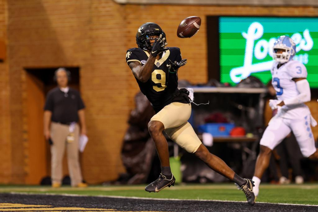 A.T. Perry (9) of the Wake Forest Demon Deacons catches a touchdown pass during a football game between the Wake Forest Demon Deacons and the North Carolina Tar Heels on Nov 12, 2022 at Truist Field in Winston-Salem, NC.